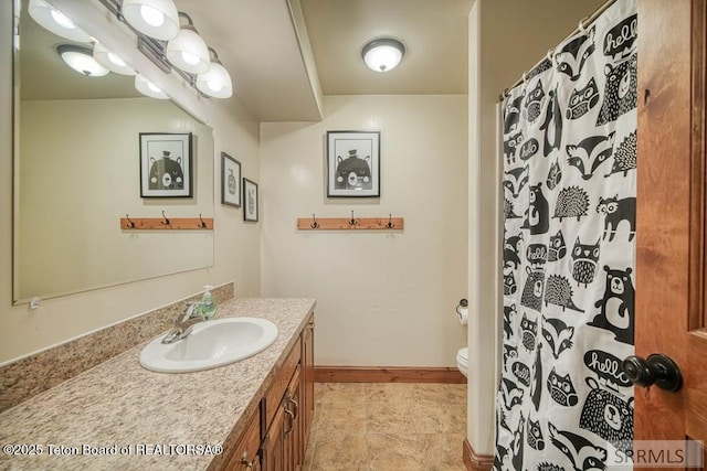 4770 Deer Dr, Island Park, ID 83429 - bathroom featuring vanity, toilet, baseboards, and a shower with curtain