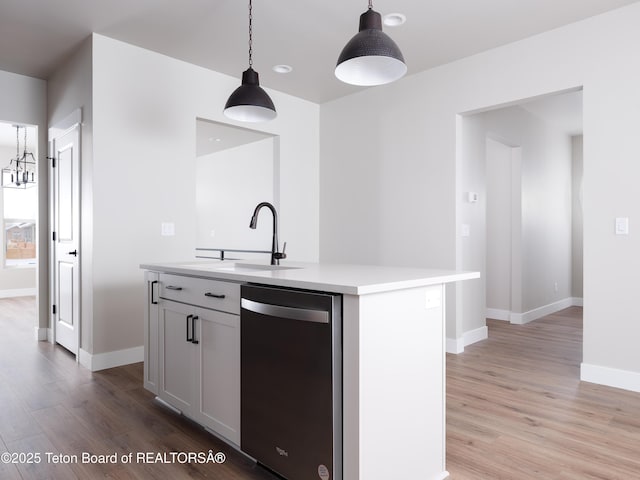 311 Bald Eagle Dr, Victor, ID 83455 - kitchen featuring dishwashing machine, a sink, light wood-style floors, and light countertops