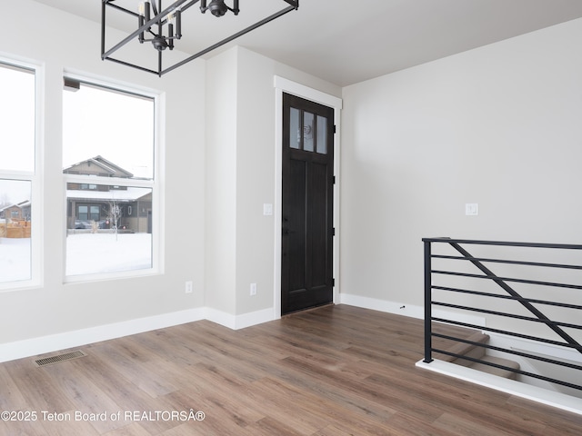 311 Bald Eagle Dr, Victor, ID 83455 - entrance foyer featuring a chandelier, wood finished floors, and baseboards