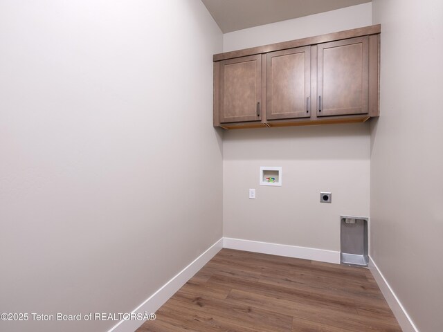 311 Bald Eagle Dr, Victor, ID 83455 - washroom featuring electric dryer hookup, washer hookup, wood finished floors, baseboards, and cabinet space
