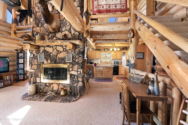 196 Soda Springs Dr, Dubois, WY 82513 - living area featuring rustic walls, a high ceiling, light colored carpet, a stone fireplace, and stairs