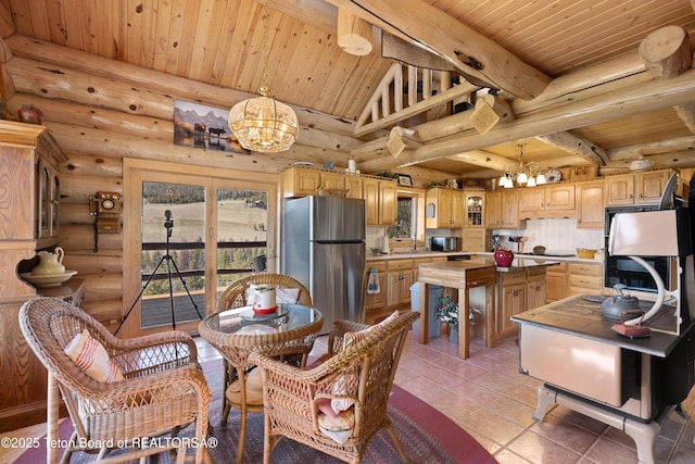 196 Soda Springs Dr, Dubois, WY 82513 - dining area featuring a chandelier, wood ceiling, rustic walls, and light tile patterned flooring