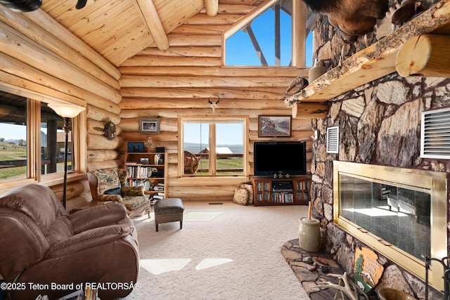 196 Soda Springs Dr, Dubois, WY 82513 - carpeted living area with high vaulted ceiling, rustic walls, a wooden ceiling with exposed beams, and a glass covered fireplace