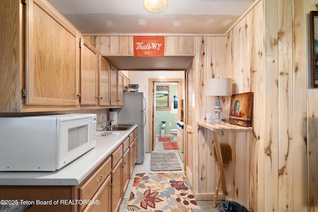 196 Soda Springs Dr, Dubois, WY 82513 - kitchen featuring white appliances, light countertops, and light brown cabinetry