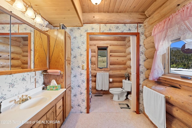 196 Soda Springs Dr, Dubois, WY 82513 - bathroom with rustic walls, wallpapered walls, vanity, a wood ceiling with exposed beams, and tile patterned flooring