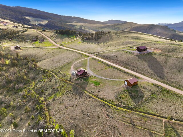 196 Soda Springs Dr, Dubois, WY 82513 - aerial overview of property's location with rural landscape and a mountain backdrop