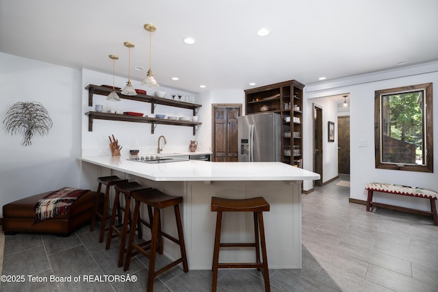 450 E Sagebrush Dr Unit 3-1-A, Jackson, WY 83001 - kitchen featuring open shelves, stainless steel fridge, a peninsula, light countertops, and recessed lighting