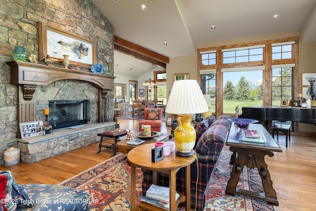 720 E Paintbrush Dr, Jackson, WY 83001 - living area featuring wood finished floors, a stone fireplace, beamed ceiling, recessed lighting, and high vaulted ceiling