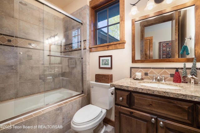720 E Paintbrush Dr, Jackson, WY 83001 - full bathroom featuring tiled shower / bath combo, backsplash, vanity, and toilet
