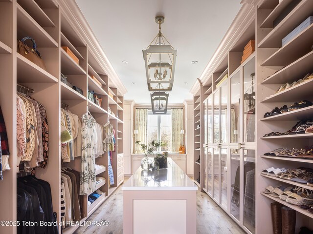 5025 Shoshone Dr, Wilson, WY 83014 - spacious closet with light wood finished floors and a chandelier