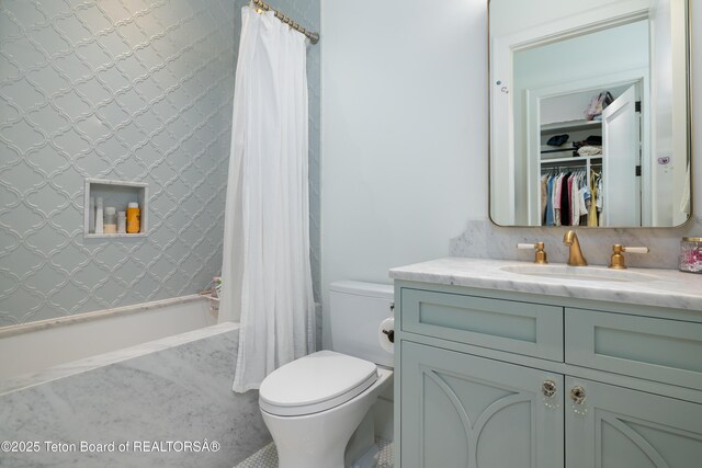 5025 Shoshone Dr, Wilson, WY 83014 - full bathroom featuring vanity, shower / bathtub combination with curtain, and a walk in closet