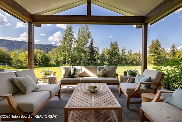 5025 Shoshone Dr, Wilson, WY 83014 - view of patio / terrace with a mountain view, outdoor lounge area, and view of wooded area