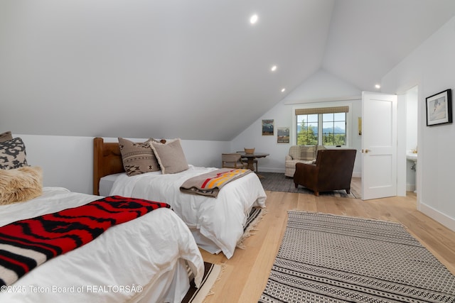 5025 Shoshone Dr, Wilson, WY 83014 - bedroom with vaulted ceiling, light wood finished floors, and recessed lighting