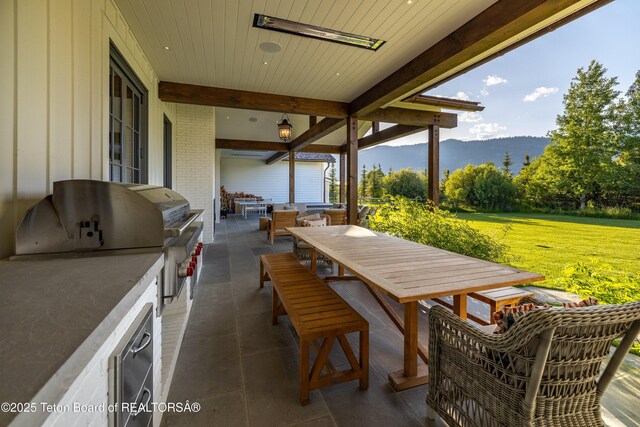 5025 Shoshone Dr, Wilson, WY 83014 - view of patio / terrace featuring area for grilling, outdoor dining space, and a mountain view
