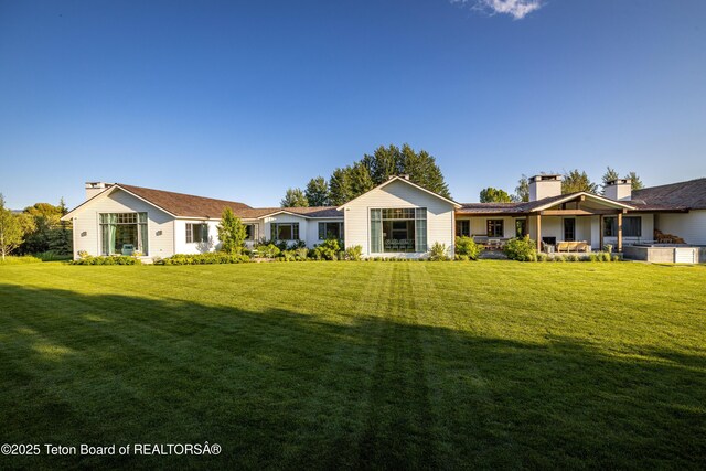 5025 Shoshone Dr, Wilson, WY 83014 - back of house with a chimney and a yard