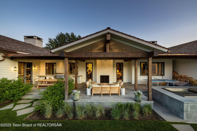 5025 Shoshone Dr, Wilson, WY 83014 - rear view of property featuring an outdoor hangout area and a patio