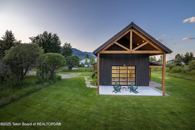 5025 Shoshone Dr, Wilson, WY 83014 - view of community with a patio area, a lawn, and a mountain view