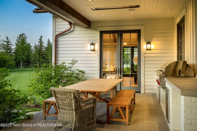 5025 Shoshone Dr, Wilson, WY 83014 - view of patio featuring an outdoor kitchen and outdoor dining space