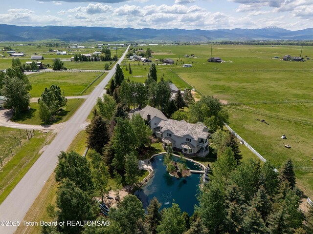 1255 Lost Crk, Thayne, WY 83127 - aerial view of property and surrounding area with rural landscape, a water and mountain view, and agricultural land