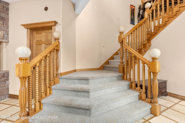 1255 Lost Crk, Thayne, WY 83127 - staircase featuring baseboards, inlaid floor details, and tile patterned flooring