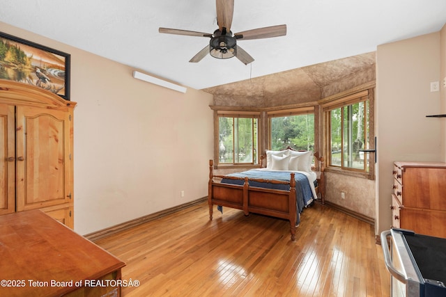 1255 Lost Crk, Thayne, WY 83127 - bedroom featuring multiple windows, baseboards, light wood-style floors, and ceiling fan