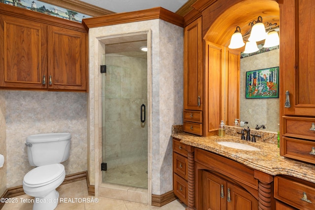 1255 Lost Crk, Thayne, WY 83127 - bathroom featuring vanity, a shower stall, toilet, tile patterned floors, and baseboards