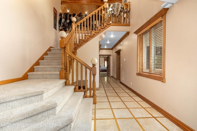 1255 Lost Crk, Thayne, WY 83127 - stairway featuring baseboards and a high ceiling