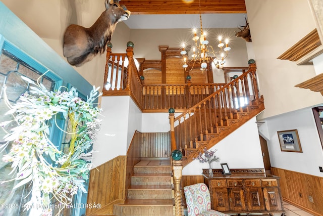1255 Lost Crk, Thayne, WY 83127 - stairs with a towering ceiling, a chandelier, wainscoting, and wooden walls