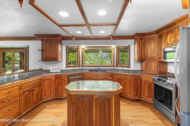 1255 Lost Crk, Thayne, WY 83127 - kitchen with stainless steel appliances, a sink, brown cabinets, a center island, and recessed lighting