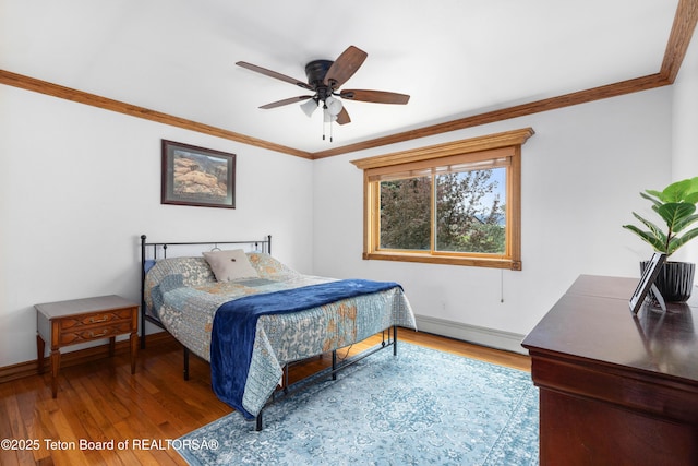 1255 Lost Crk, Thayne, WY 83127 - bedroom featuring a baseboard heating unit, ornamental molding, wood finished floors, baseboards, and a ceiling fan