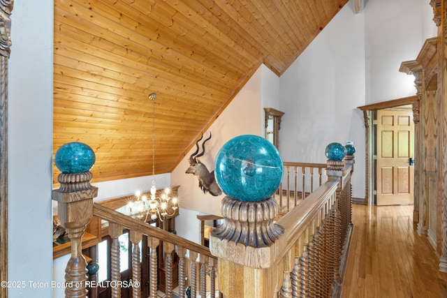 1255 Lost Crk, Thayne, WY 83127 - hall featuring a chandelier, wooden ceiling, vaulted ceiling, an upstairs landing, and hardwood / wood-style flooring