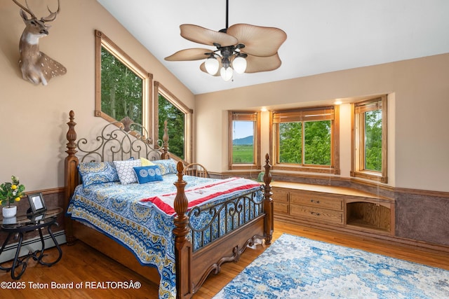 1255 Lost Crk, Thayne, WY 83127 - bedroom featuring wood finished floors, a baseboard radiator, and a ceiling fan