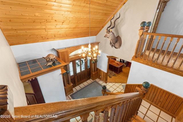 1255 Lost Crk, Thayne, WY 83127 - staircase with a chandelier, wooden ceiling, lofted ceiling, and wood walls