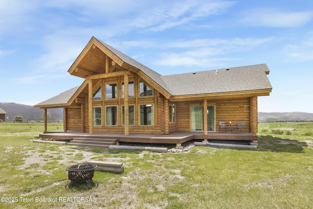 105 Elk Path, Swan Valley, ID 83428 - rear view of property featuring an outdoor fire pit, log siding, and a shingled roof