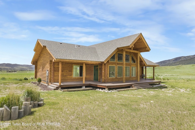 105 Elk Path, Swan Valley, ID 83428 - back of house featuring a shingled roof, a lawn, log siding, and a deck with mountain view