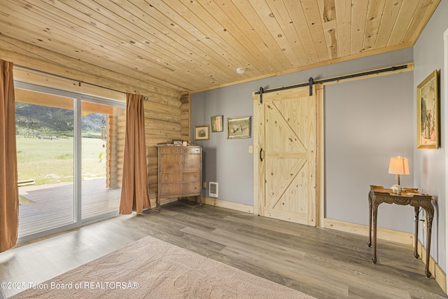 105 Elk Path, Swan Valley, ID 83428 - empty room featuring rustic walls, a barn door, wooden ceiling, and wood finished floors