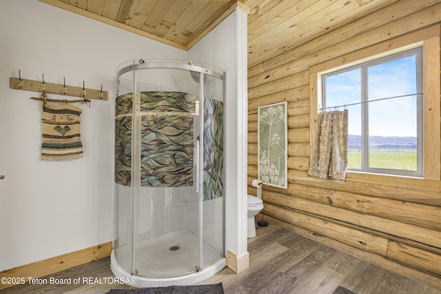 105 Elk Path, Swan Valley, ID 83428 - bathroom with log walls, wooden ceiling, toilet, wood finished floors, and a shower stall