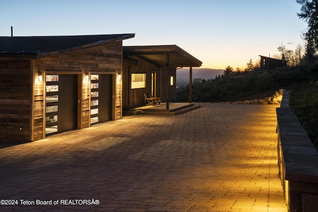 5170 Meandering Moose Dr, Victor, ID 83455 - patio terrace at dusk featuring a garage