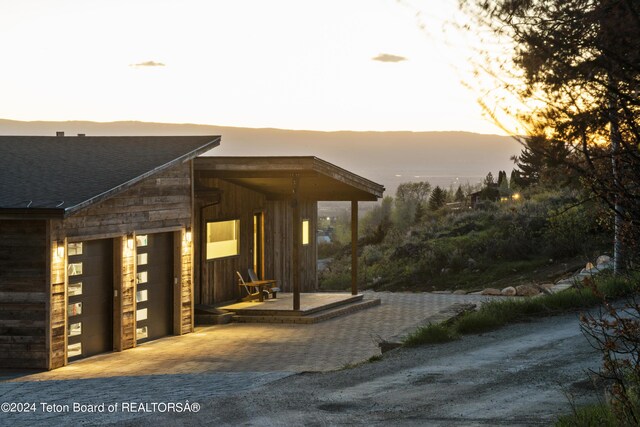 5170 Meandering Moose Dr, Victor, ID 83455 - patio terrace at dusk featuring a garage