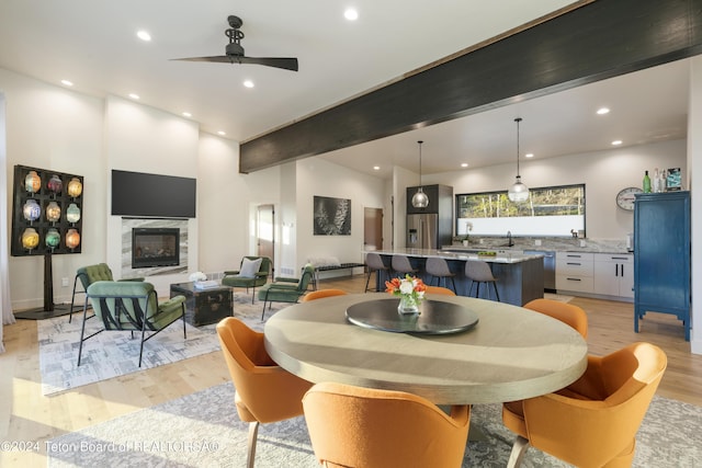 5170 Meandering Moose Dr, Victor, ID 83455 - dining room featuring light wood finished floors, ceiling fan, recessed lighting, and beam ceiling