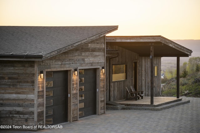 5170 Meandering Moose Dr, Victor, ID 83455 - doorway to property with a shingled roof and an attached garage