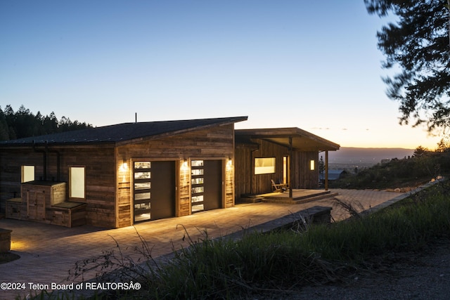 5170 Meandering Moose Dr, Victor, ID 83455 - property exterior at dusk featuring a garage