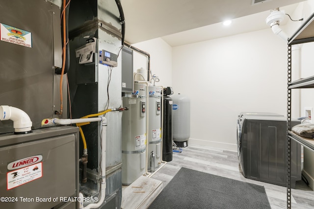 5170 Meandering Moose Dr, Victor, ID 83455 - utility room with washer and clothes dryer, heating unit, and strapped water heater