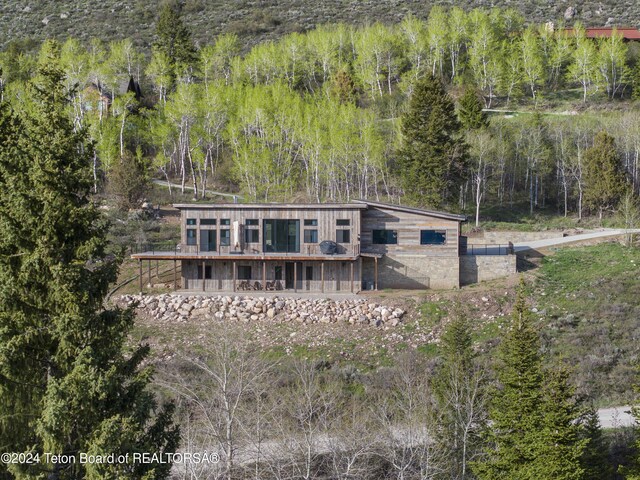 5170 Meandering Moose Dr, Victor, ID 83455 - rear view of property with a wooded view