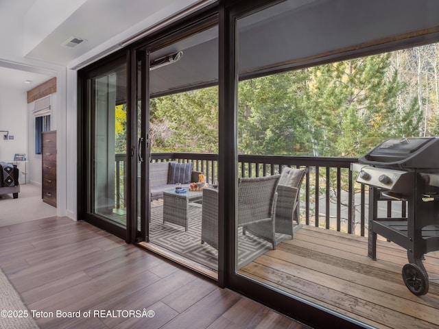 7280 N Rachel Way Unit B-7, Teton Village, WY 83025 - doorway to outside featuring wood finished floors and plenty of natural light