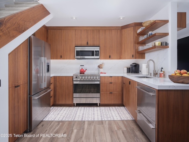 7280 N Rachel Way Unit B-7, Teton Village, WY 83025 - kitchen featuring appliances with stainless steel finishes, a sink, brown cabinetry, open shelves, and tasteful backsplash