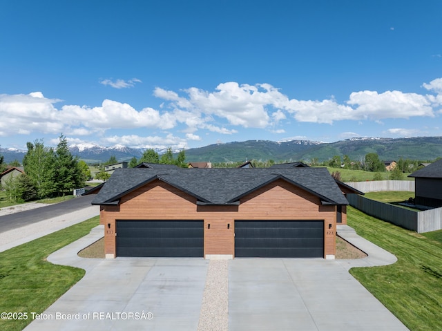 833 Booshway St, Driggs, ID 83422 - contemporary house featuring a mountain view, concrete driveway, and a shingled roof