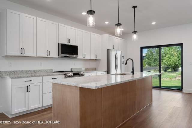 833 Booshway St, Driggs, ID 83422 - kitchen featuring appliances with stainless steel finishes, dark wood finished floors, a sink, a center island with sink, and recessed lighting