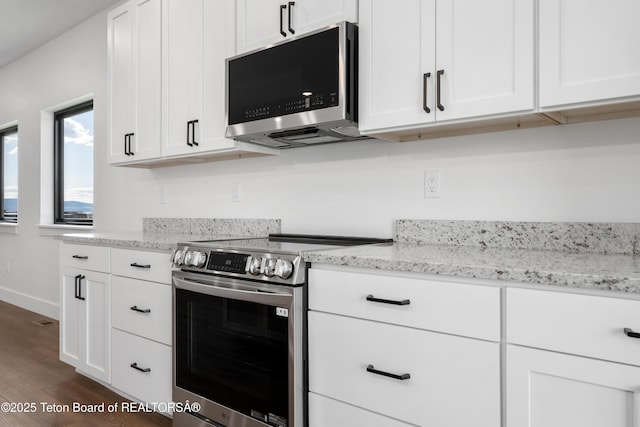 833 Booshway St, Driggs, ID 83422 - kitchen with appliances with stainless steel finishes, dark wood-type flooring, and white cabinets
