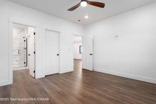 833 Booshway St, Driggs, ID 83422 - unfurnished bedroom with dark wood-style flooring, baseboards, ensuite bathroom, and recessed lighting